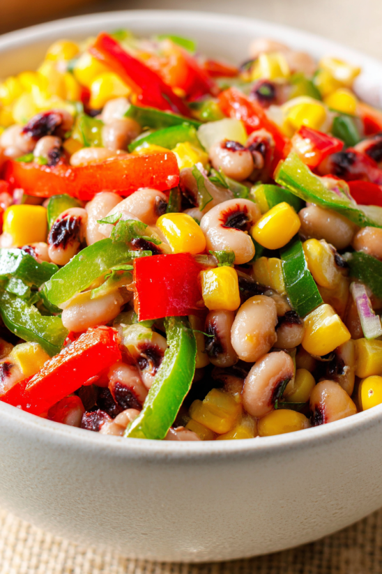 A bowl of food with beans, corn, and peppers.