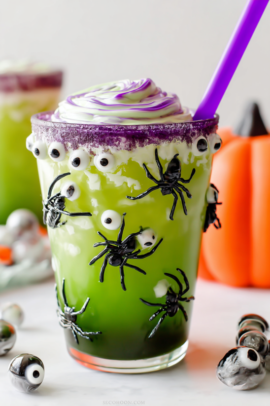 A green drink with black spiders on it.