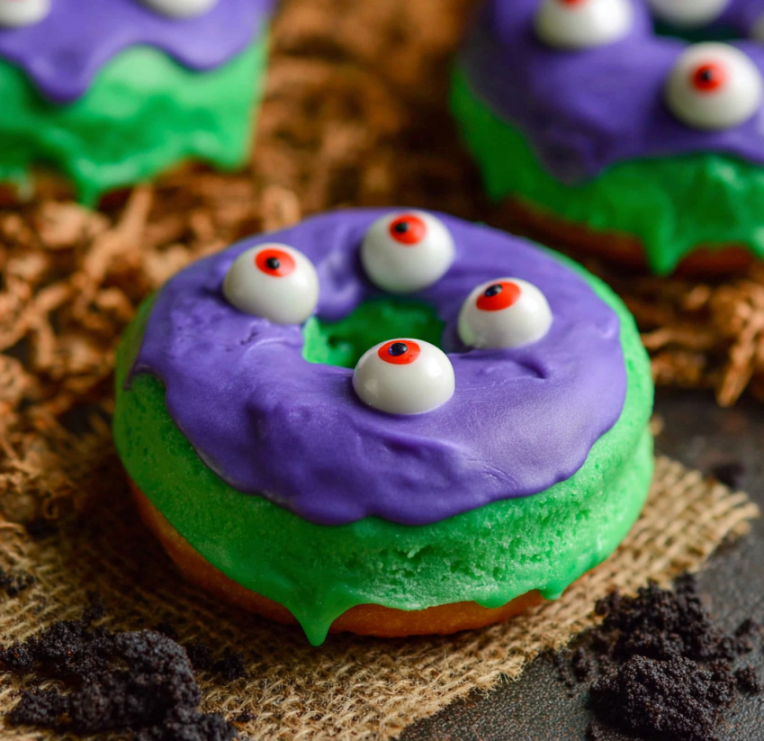 A green and purple donut with eyes.