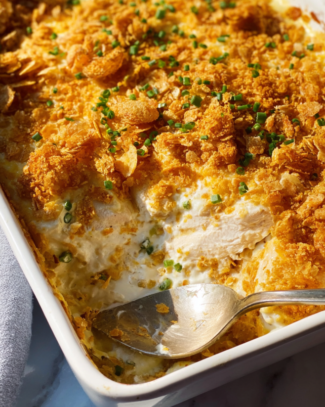 A dish of chicken casserole with a spoon in it.