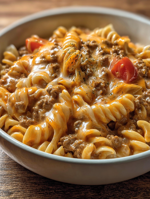 A bowl of pasta with meat and cheese.