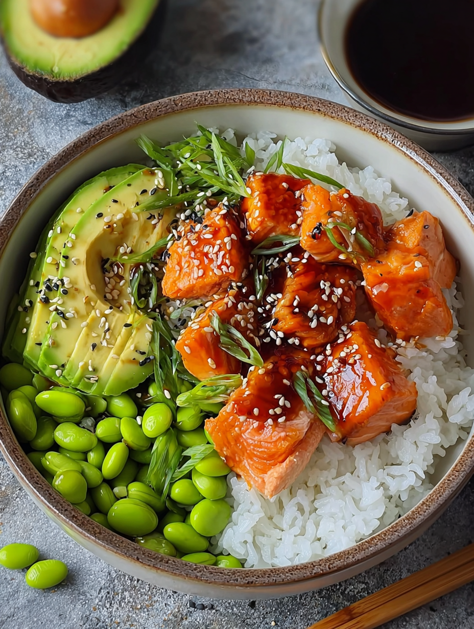 A bowl of sushi with rice, avocado, and salmon.