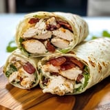 Two chicken bacon ranch wraps on a table.