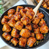 A bowl of honey garlic chicken bites.