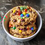 A bowl of chocolate chip cookies with M&M's.