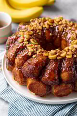 A cake with nuts on top.