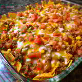 A glass bowl filled with nachos.