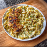 A plate of food with chicken and pasta.