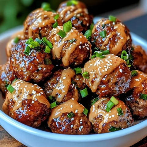 A bowl of meatballs with a spicy mayo dip.